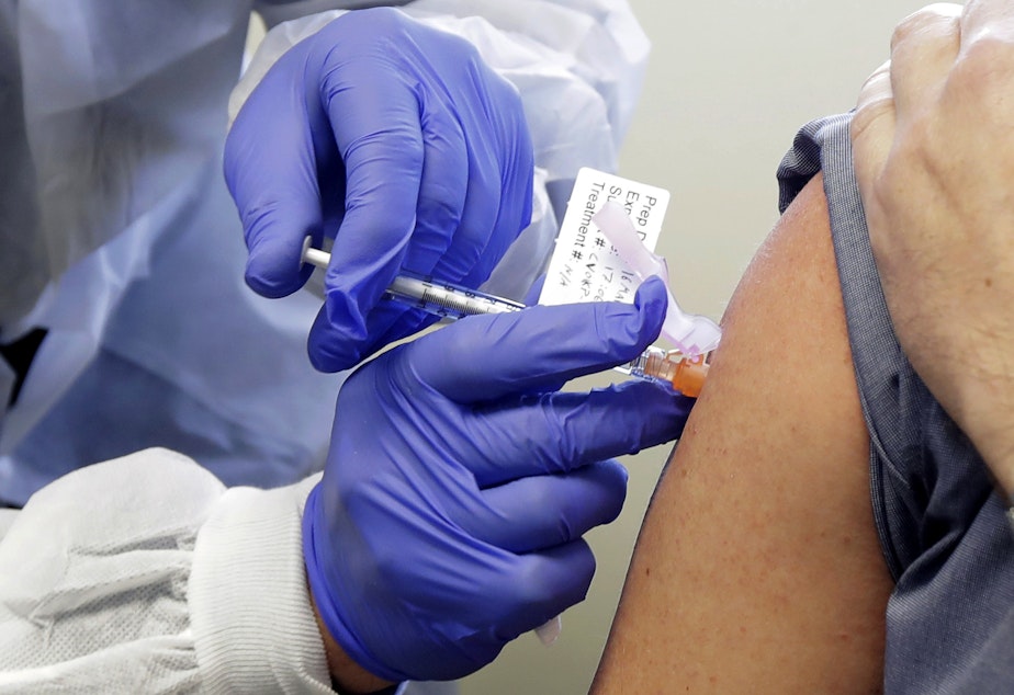 caption: A volunteer received a shot of the experimental Moderna vaccine against COVID-19 in March as part of a safety study.