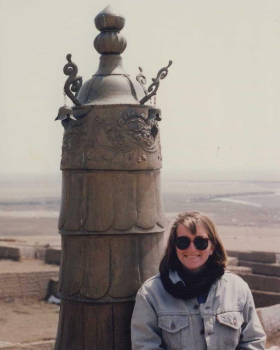 caption: Stephanie Hogan posing in front of the Ta'er Si Lamastery (Buddhist Lama Monastery) in Qinghai Province, China. Taken in May 1989.