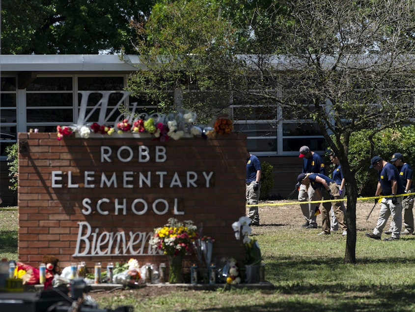 caption: Investigators search for evidence outside Robb Elementary School in Uvalde, Texas, May 25, 2022, after an 18-year-old gunman killed 19 students and two teachers. Four months after the Robb Elementary School shooting, the Uvalde school district on Friday, Oct. 7 pulled its entire embattled campus police force off the job.