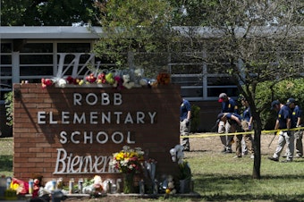caption: Investigators search for evidence outside Robb Elementary School in Uvalde, Texas, May 25, 2022, after an 18-year-old gunman killed 19 students and two teachers. Four months after the Robb Elementary School shooting, the Uvalde school district on Friday, Oct. 7 pulled its entire embattled campus police force off the job.