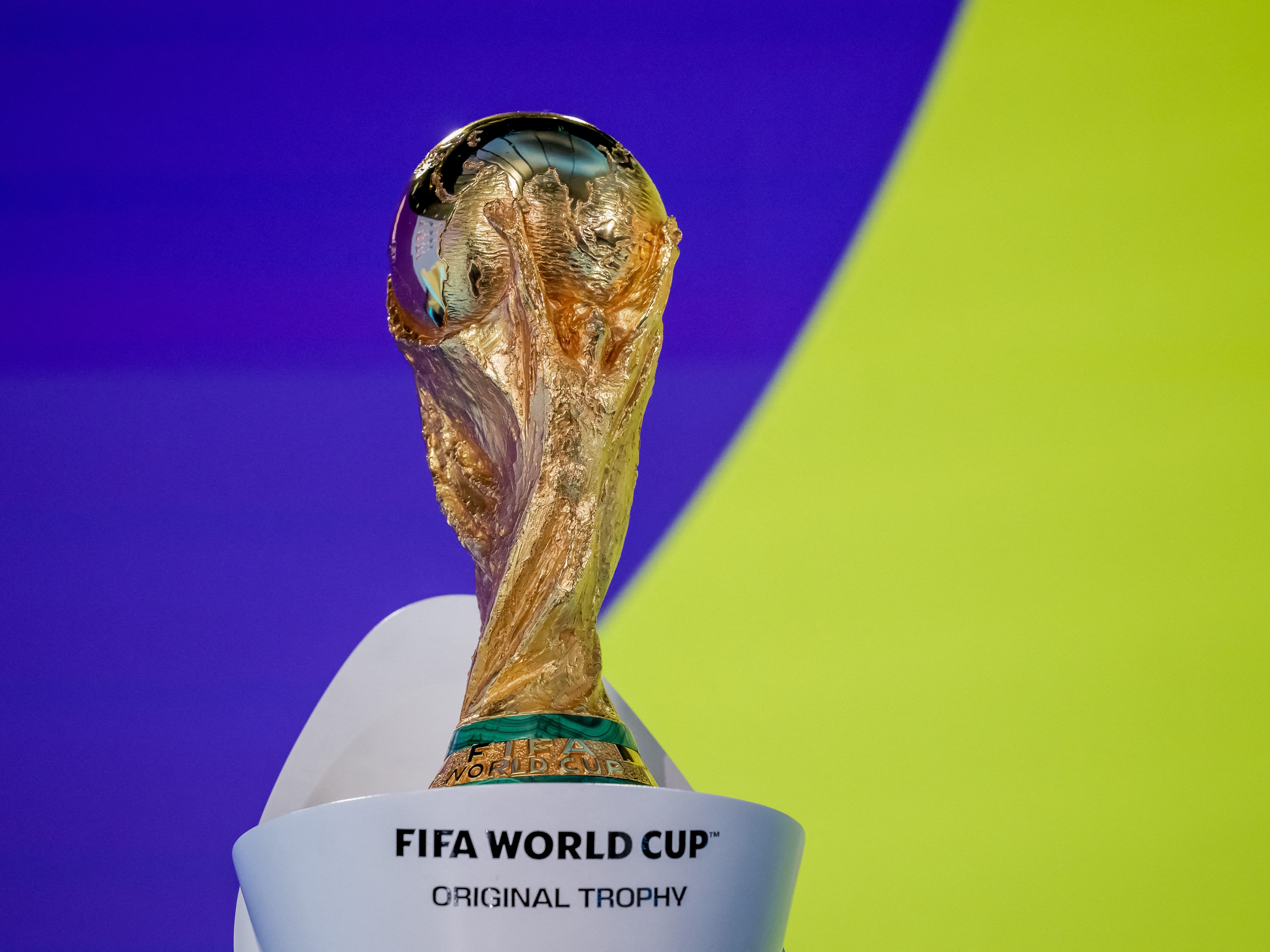 caption: The FIFA World Cup trophy is on display at an event in Zurich on Nov. 20.