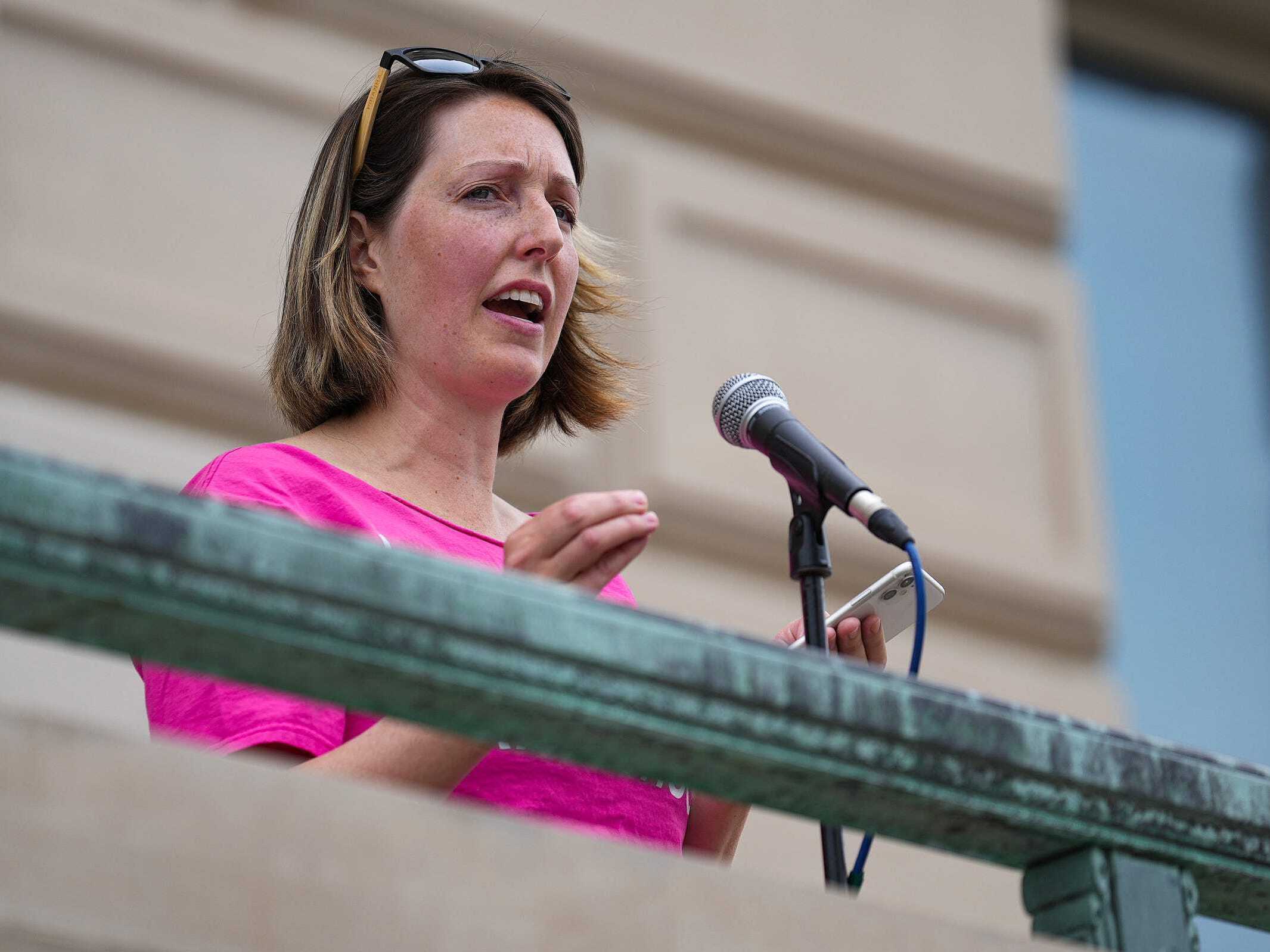 caption: Dr. Caitlin Bernard, the Indiana doctor who provided an abortion to a 10-year-old rape victim from Ohio, speaks during an abortion rights rally in June at the Indiana Statehouse.