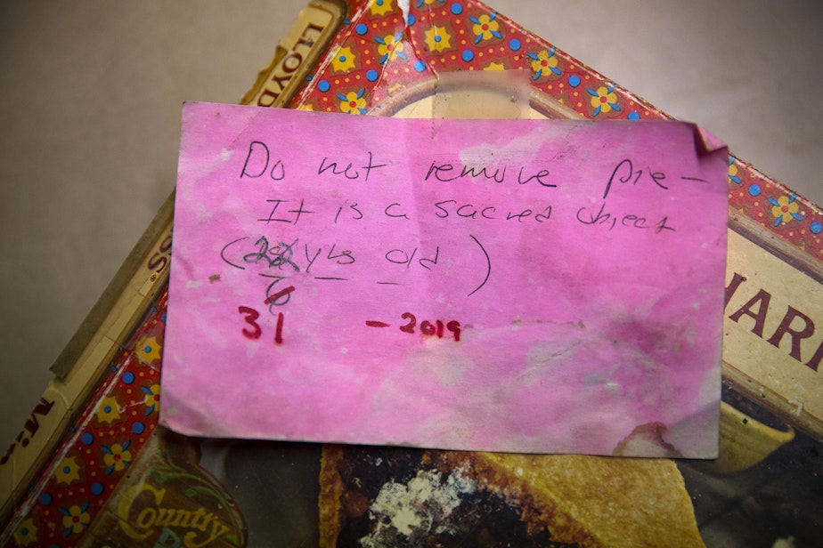caption: A note taped to a mincemeat pie box reads 'Do not remove pie - it is a sacred object' on Friday, November 22, 2019, at the home of Sheila Kelly in Seattle. Her mother, Helen May Kelly, purchased the pie but died before the pie could be consumed. Kelly has kept the pie in her fridge ever since. 