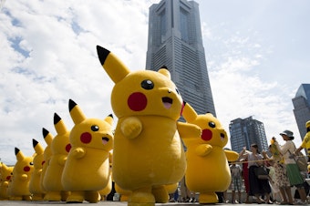 caption: Performers dressed as Pikachu, a character from Pokemon series, march during the Pikachu Outbreak event hosted by The Pokemon Co. on August 9, 2017 in Yokohama, Kanagawa, Japan.