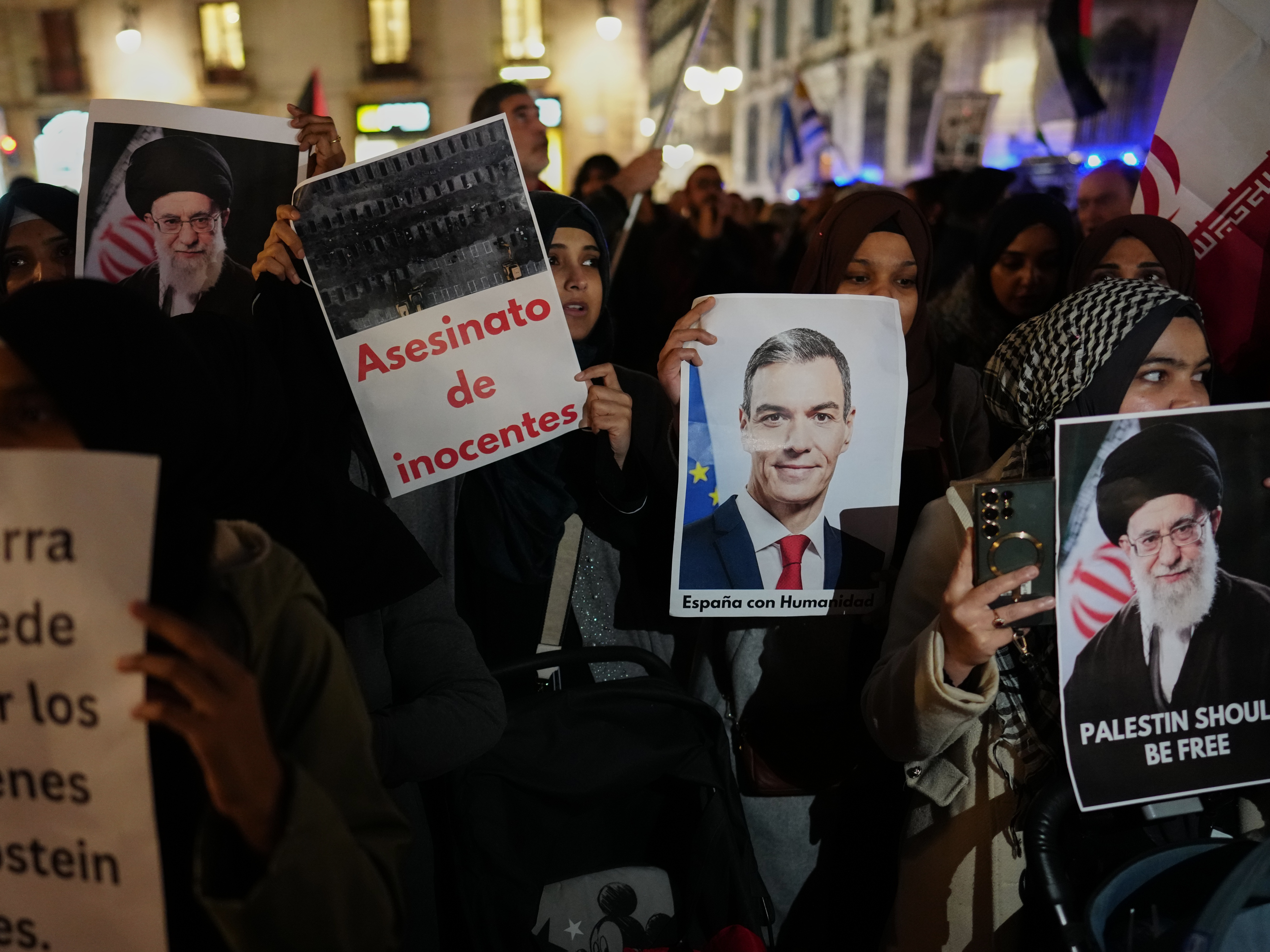 caption: Demonstrators hold photographs of the killed Iranian supreme leader and Spanish Prime Minister Pedro Sánchez during a protest against U.S. and Israeli military attacks in Iran in Barcelona, Spain, on Wednesday.
