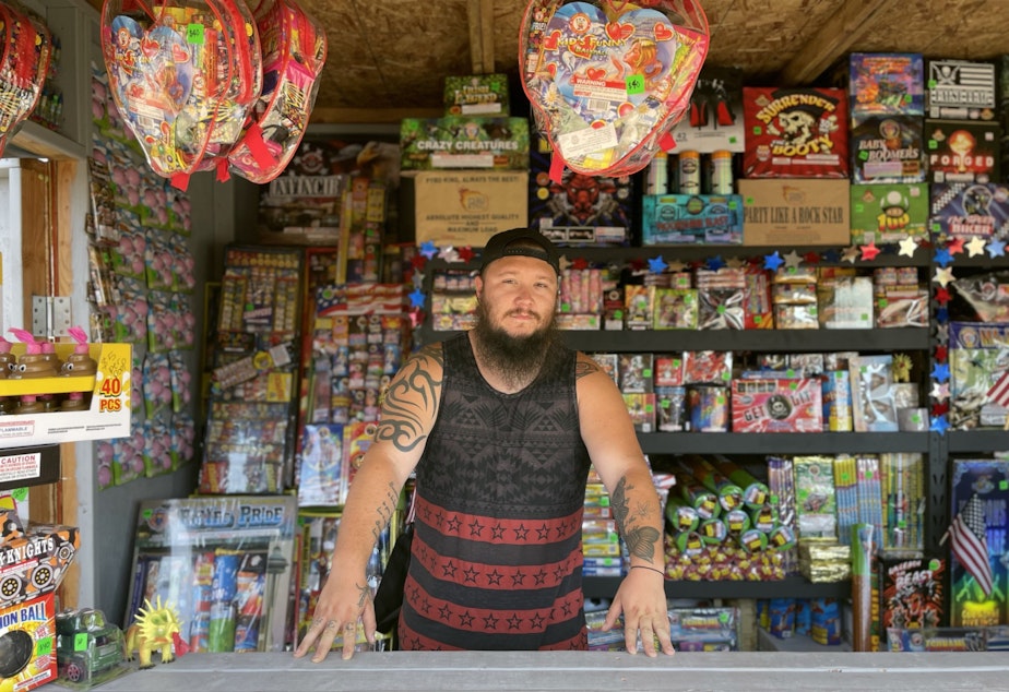 caption: Justin Edwards at Boom Box Fireworks, in Firecracker Alley, on Puyallup land near the Port of Tacoma.