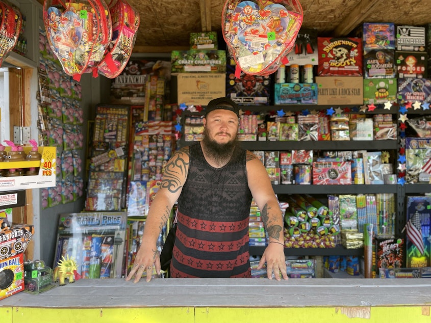 caption: Justin Edwards at Boom Box Fireworks, in Firecracker Alley, on Puyallup land near the Port of Tacoma.