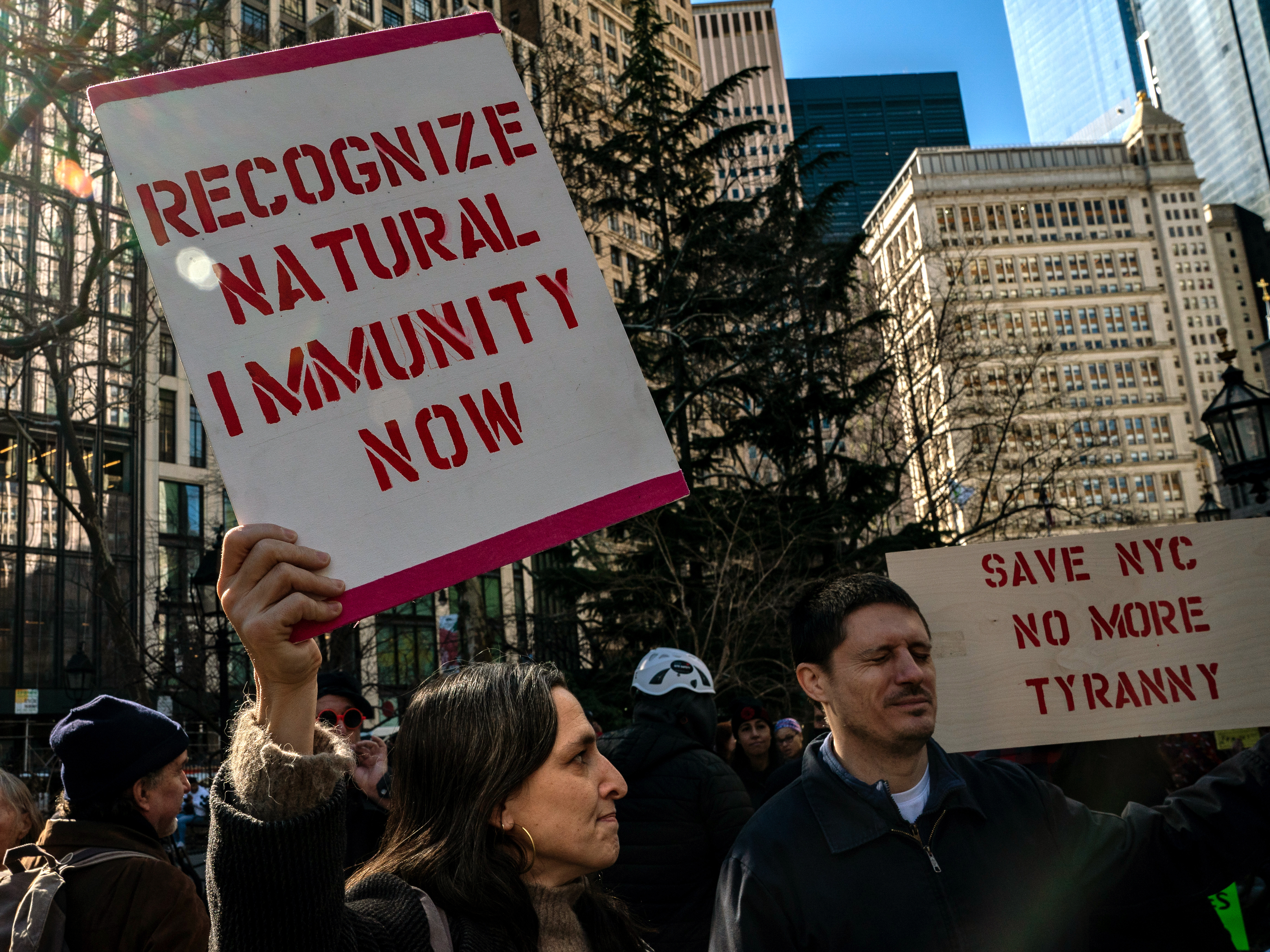 caption: People gather at City Hall to protest New York City's vaccine mandate for public employees on Feb. 11, the day that many were fired.