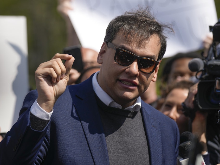 caption: U.S. Rep. George Santos, R-N.Y., speaks to the media outside the federal courthouse in Central Islip, N.Y., Wednesday. The next day, he appeared virtually in a Brazilian court to face separate charges.