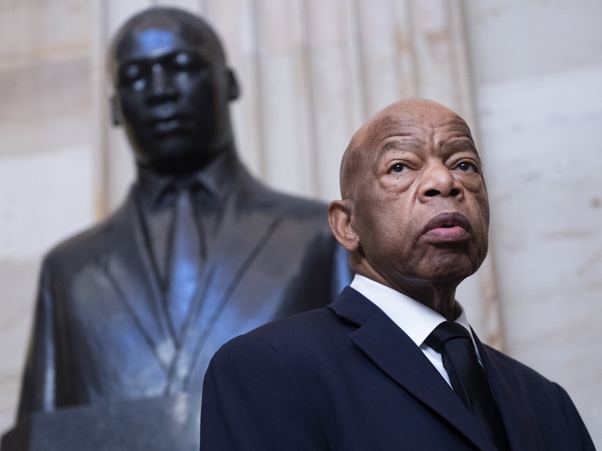 caption: Georgia Rep. John Lewis near the statue of Martin Luther King Jr. in the Capitol Rotunda in Washington, D.C., earlier this year. At StoryCorps in 2018, Lewis talked about meeting King in Montgomery, Ala., at 18.