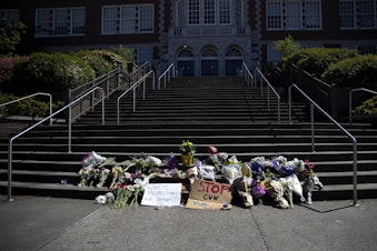 caption: A growing memorial for a 17-year-old student who was shot and killed is shown on Friday, June 7, 2024, at Garfield High School in Seattle. 