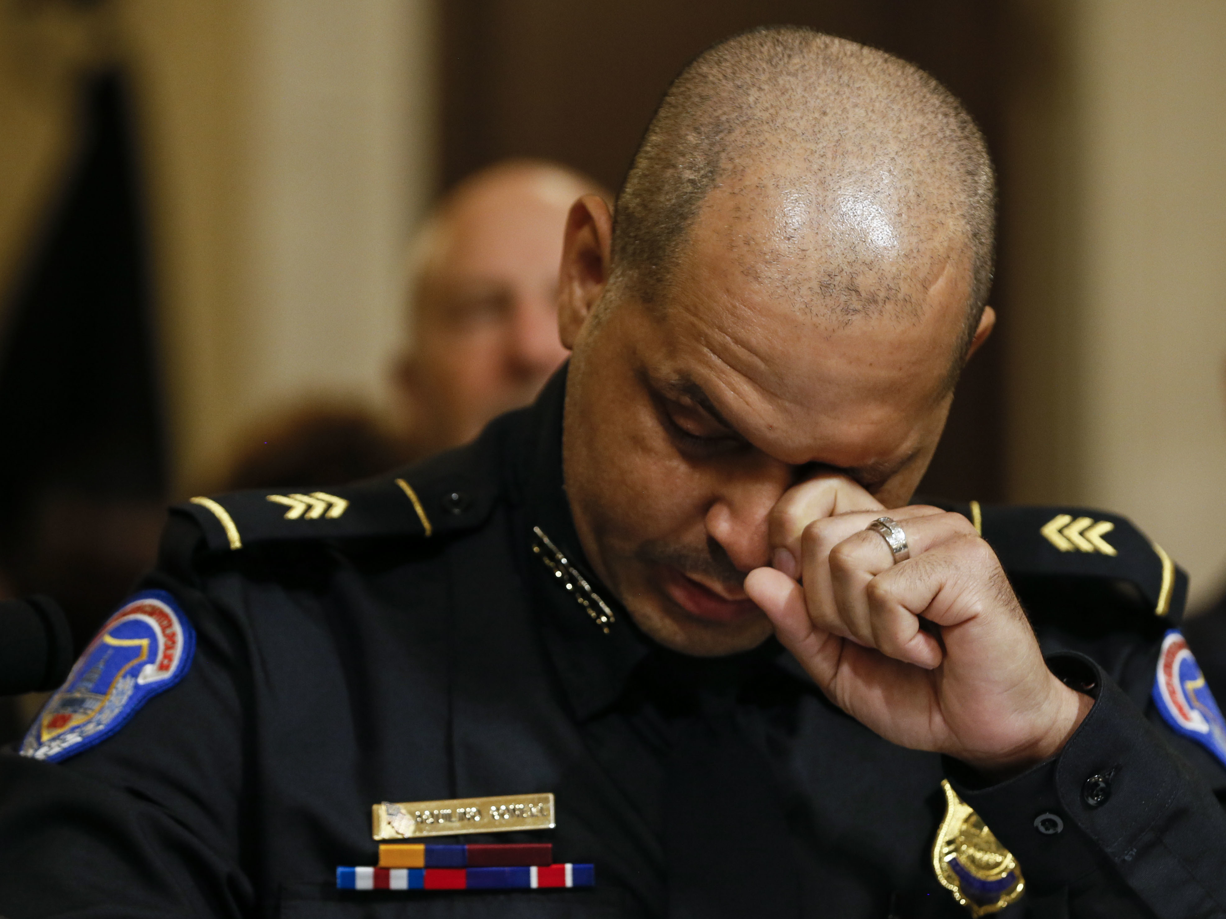 caption: U.S. Capitol Police Sgt. Aquilino Gonell wipes tears while testifying Tuesday during the opening hearing of the House select committee investigating the Jan. 6 attack on the U.S. Capitol.