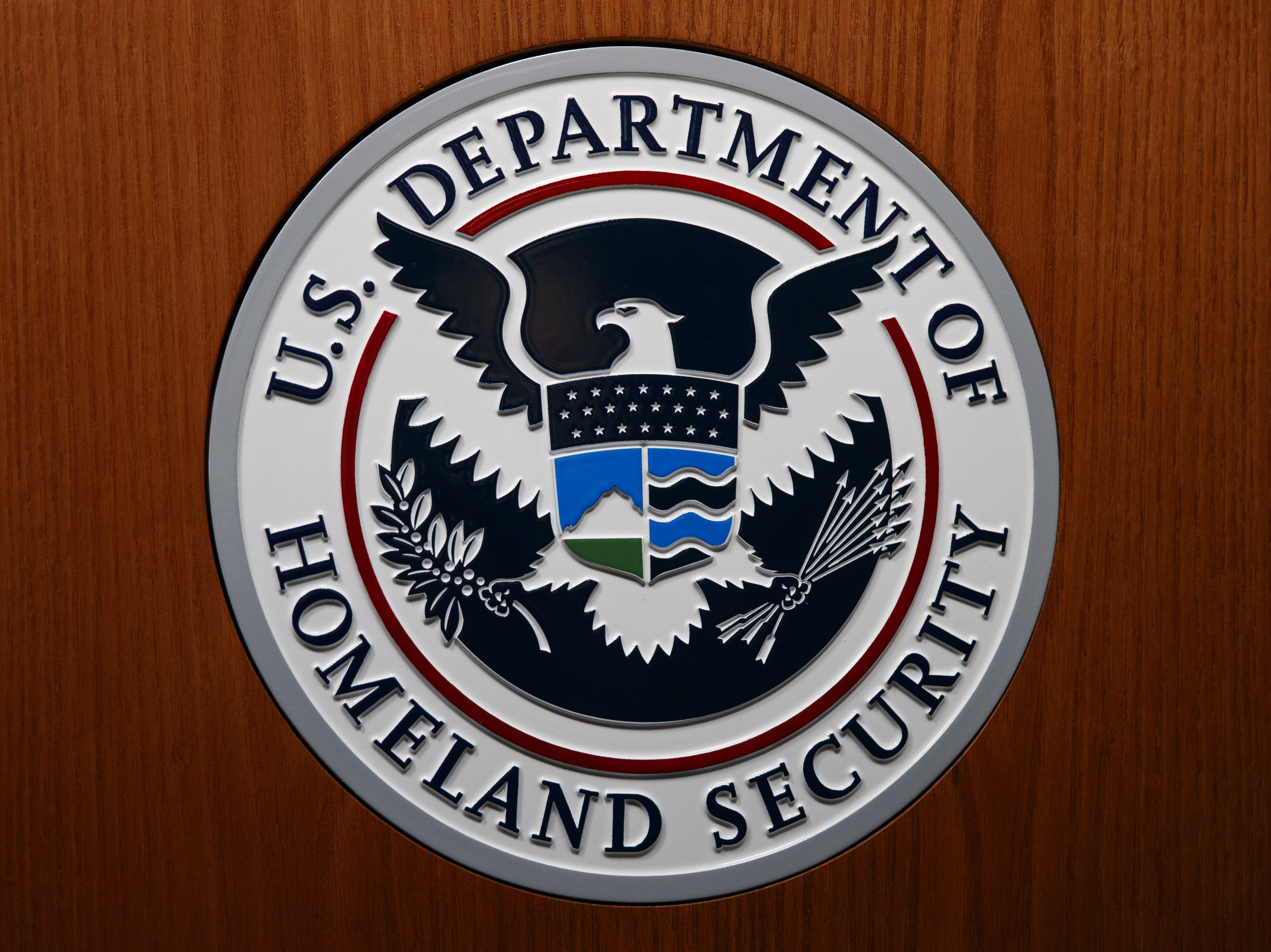 caption: The Department of Homeland Security (DHS) seal is a photograph taken in Washington, D.C., in June.