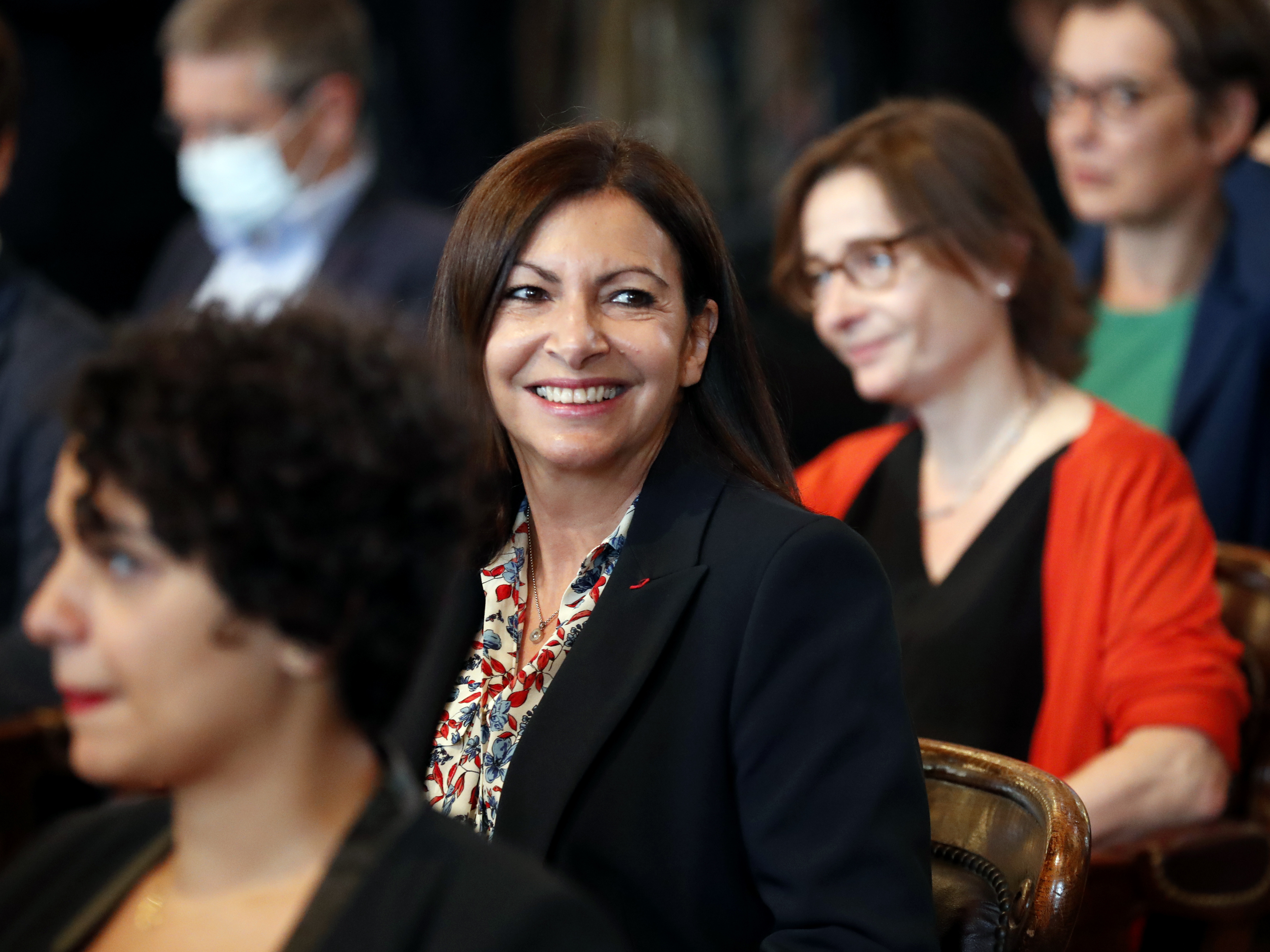 caption: Paris Mayor Anne Hidalgo  (center) at a Paris council meeting in July after winning reelection.