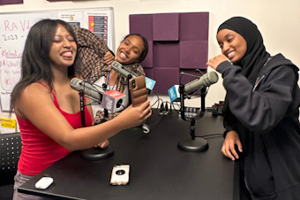 caption: Red Debebe (left), Eliham Mohammed (center) and  Maymuna Yusuf in the RadioActive Youth Media studio.