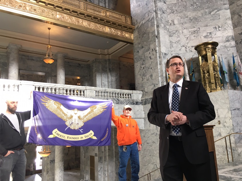 caption: State Rep. Matt Shea speaks at a 51st state rally in the Capitol in February. 