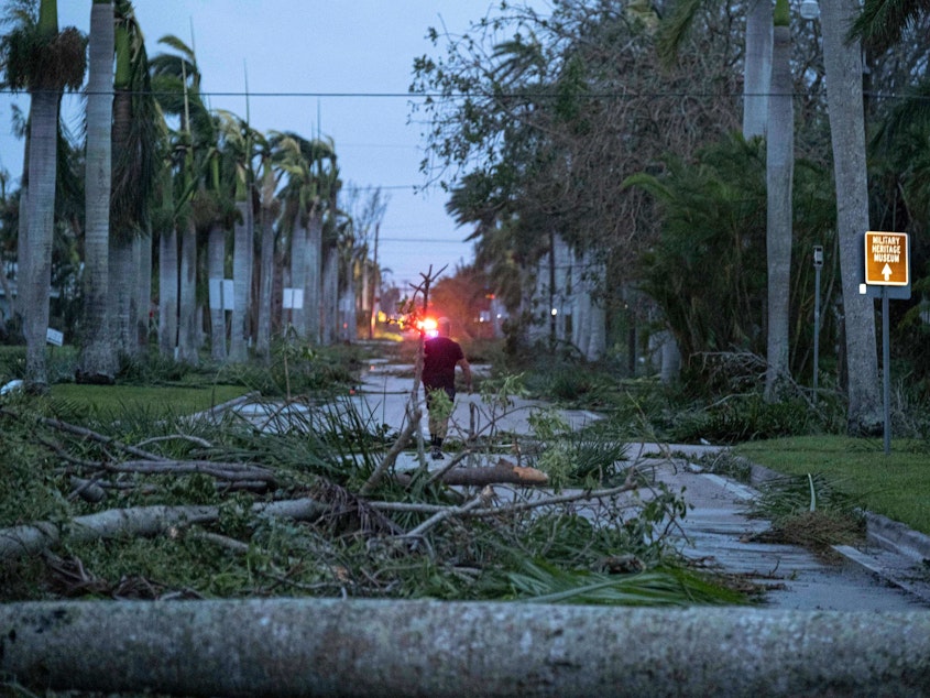 caption: Hurricane Ian left debris in Punta Gorda, Fla. after it made landfall. Storms like Ian are more likely because of climate change.