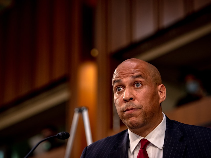 caption: Sen. Cory Booker looks on as Supreme Court nominee Judge Amy Coney Barrett testifies before the Senate Judiciary Committee on the second day of her Supreme Court confirmation hearing Tuesday.