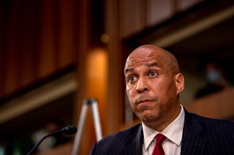 caption: Sen. Cory Booker looks on as Supreme Court nominee Judge Amy Coney Barrett testifies before the Senate Judiciary Committee on the second day of her Supreme Court confirmation hearing Tuesday.