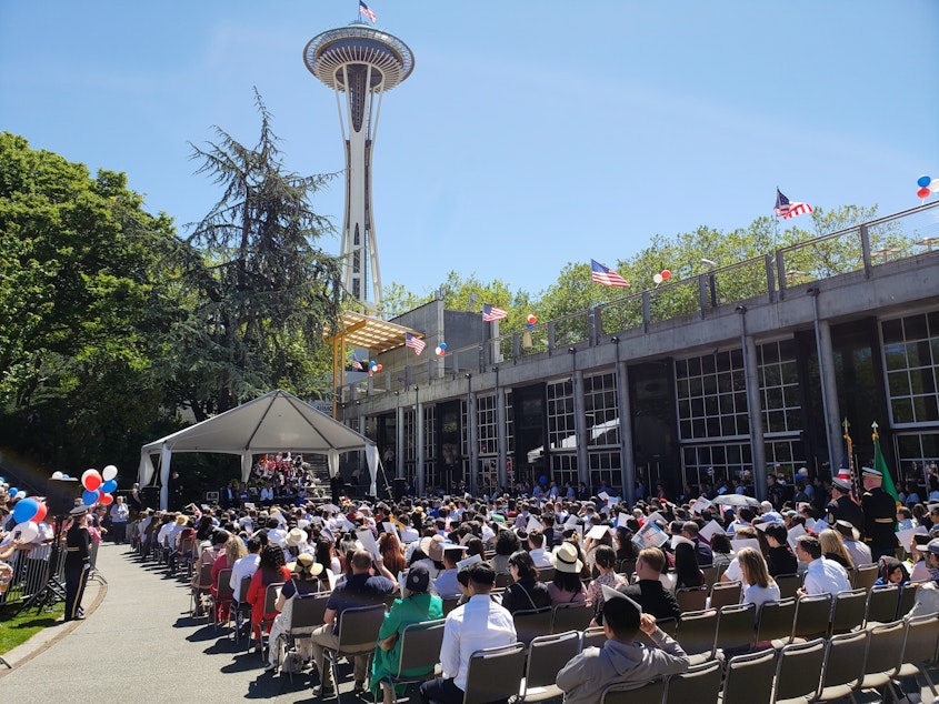 caption: Hundreds sit at the annual naturalization ceremony at Seattle Center on Thursday, July 4, 2024.