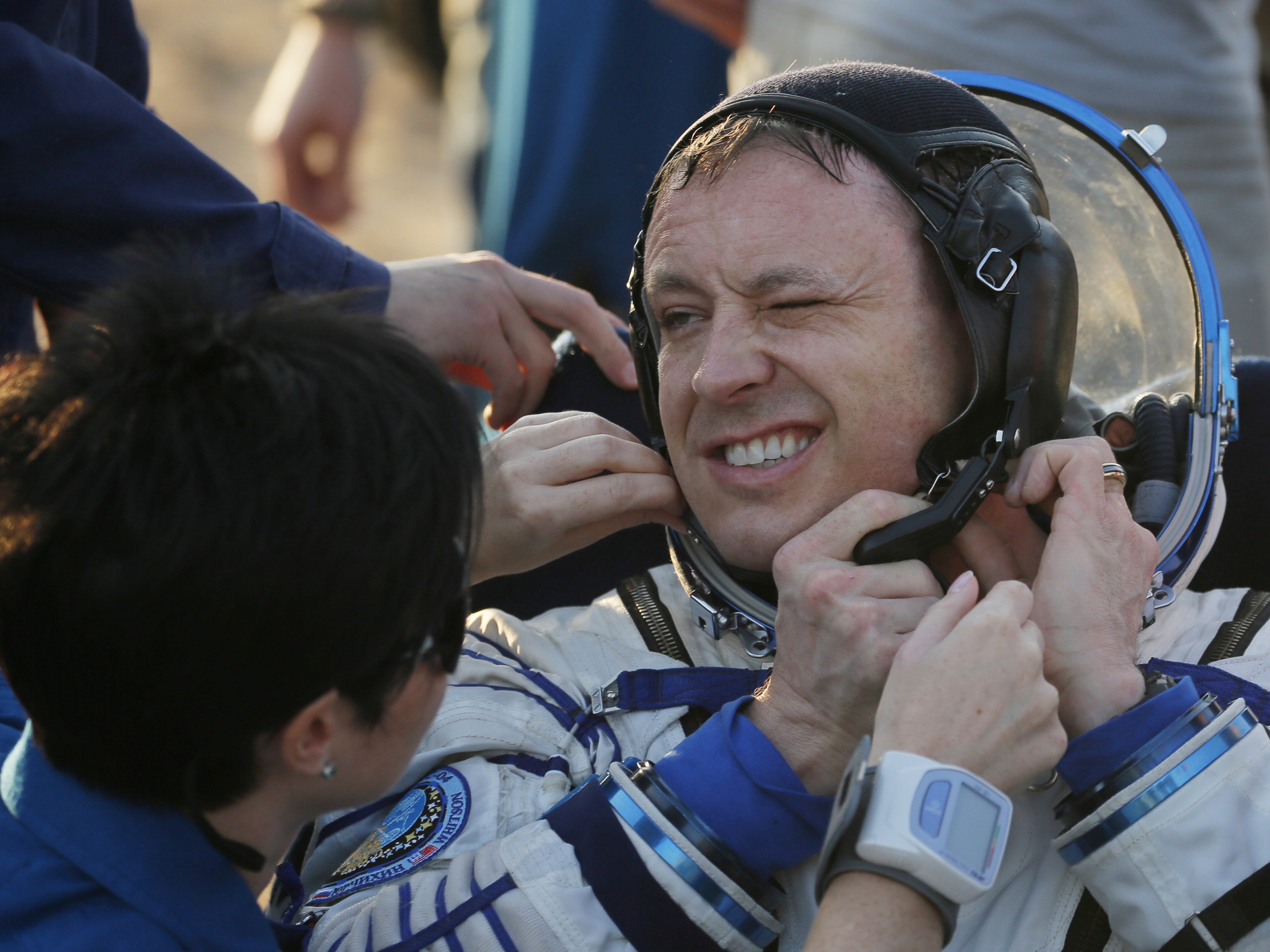 caption: Ground personnel help U.S. astronaut Jack Fischer after he landed in a remote area outside  Dzhezkazgan, Kazakhstan, Sunday, Sept. 3, 2017.