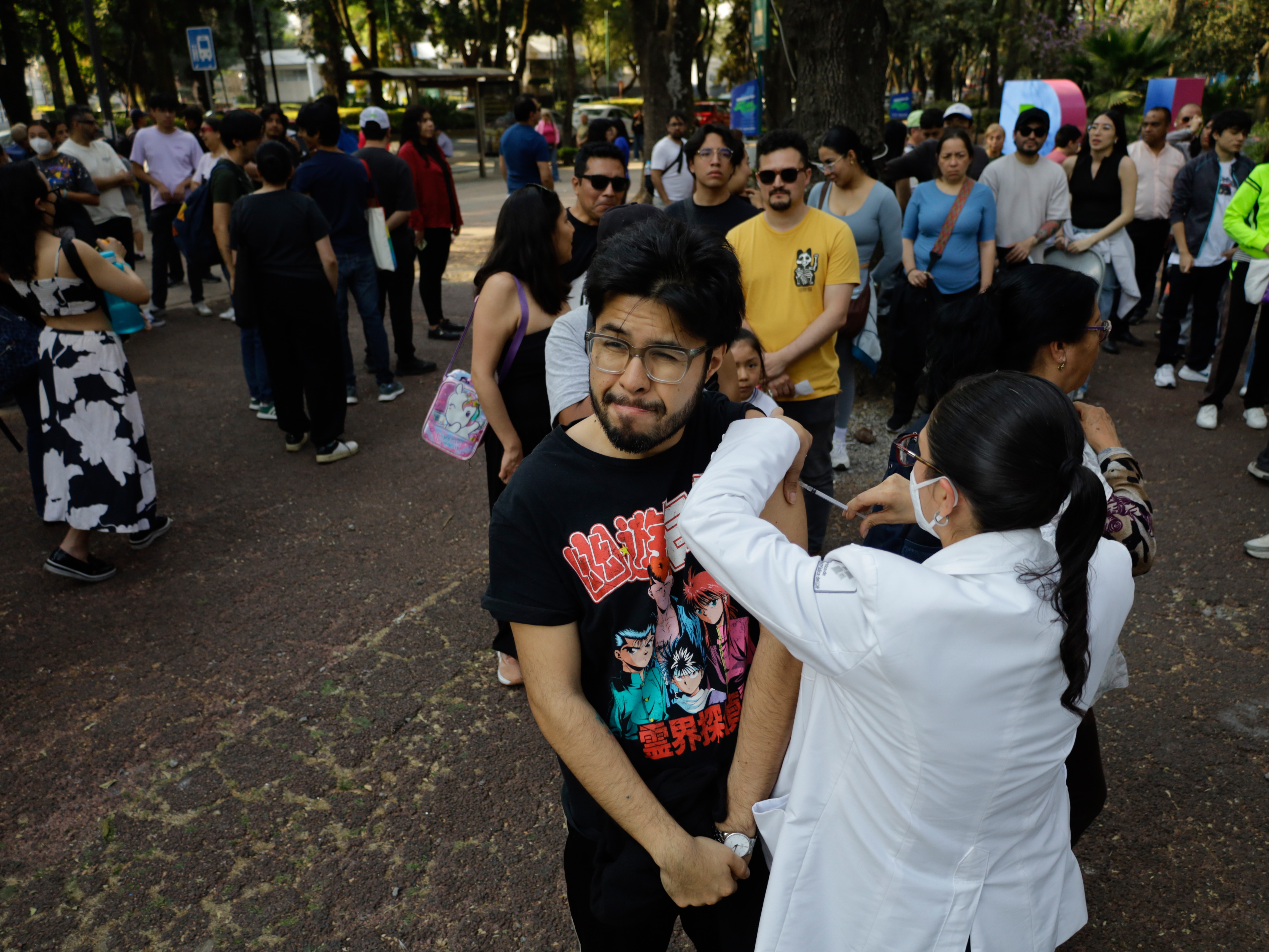 caption: Medical personnel in Mexico City administer measles vaccines at a mass vaccination event on February 11.