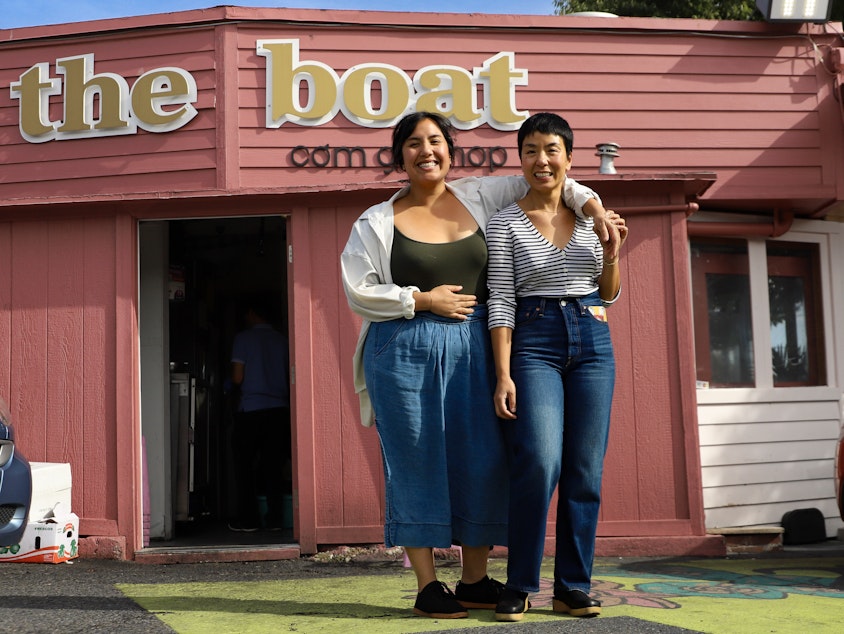 caption: Yenvy and Quynh Pham in front of The Boat Restaurant in Seattle