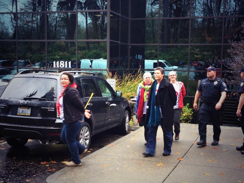 caption: Peggy Lynch, in the blue scarf, wife of Seattle Mayor Mike McGinn, was arrested on Thursday for being part of a sit-in at the state's Republican Party headquarters.