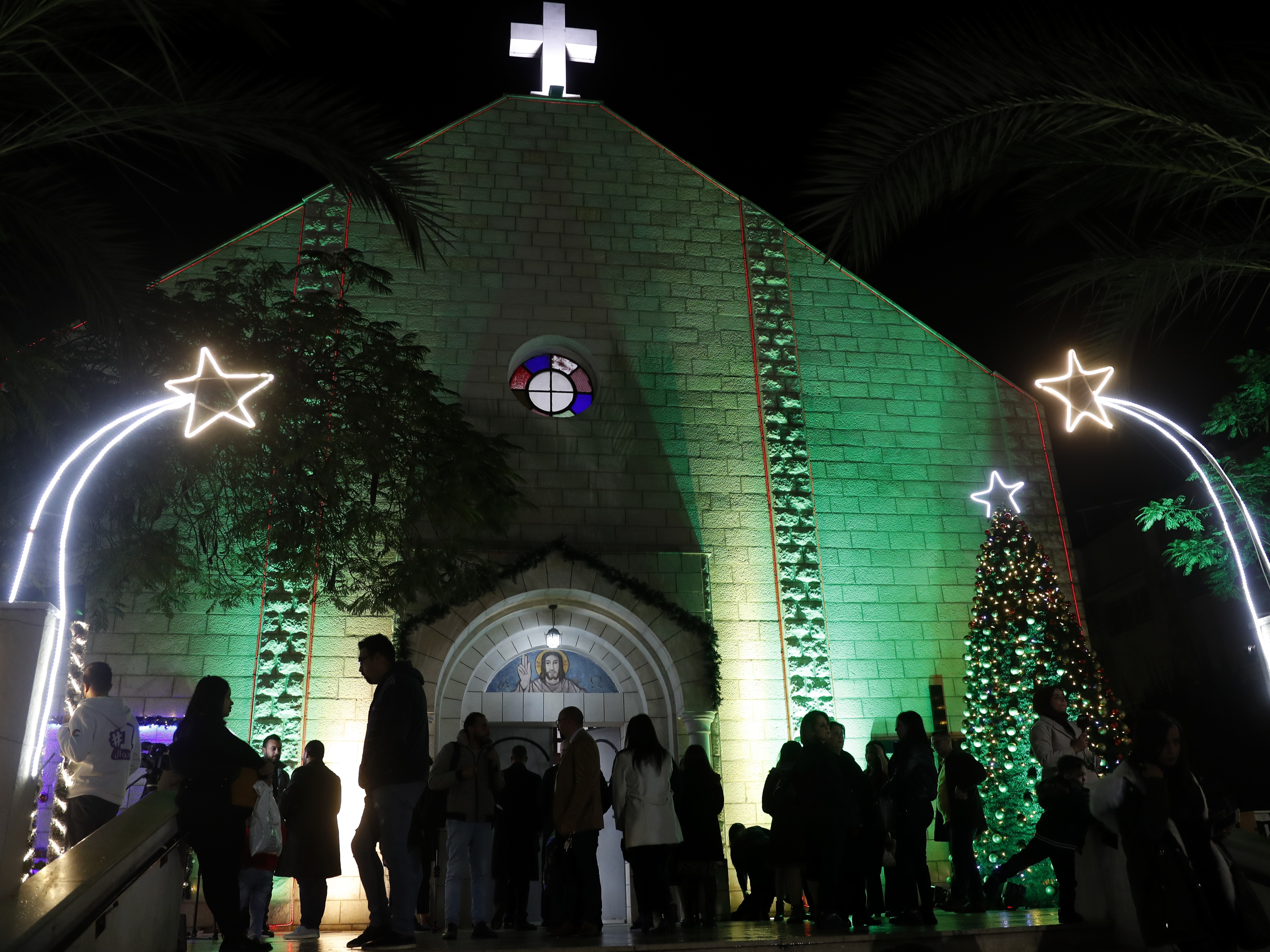 caption: Palestinian Christians wait to pray at the midnight Christmas Eve Mass out side the Deir Al Latin Holy Family Catholic Church in Gaza City, 2021.