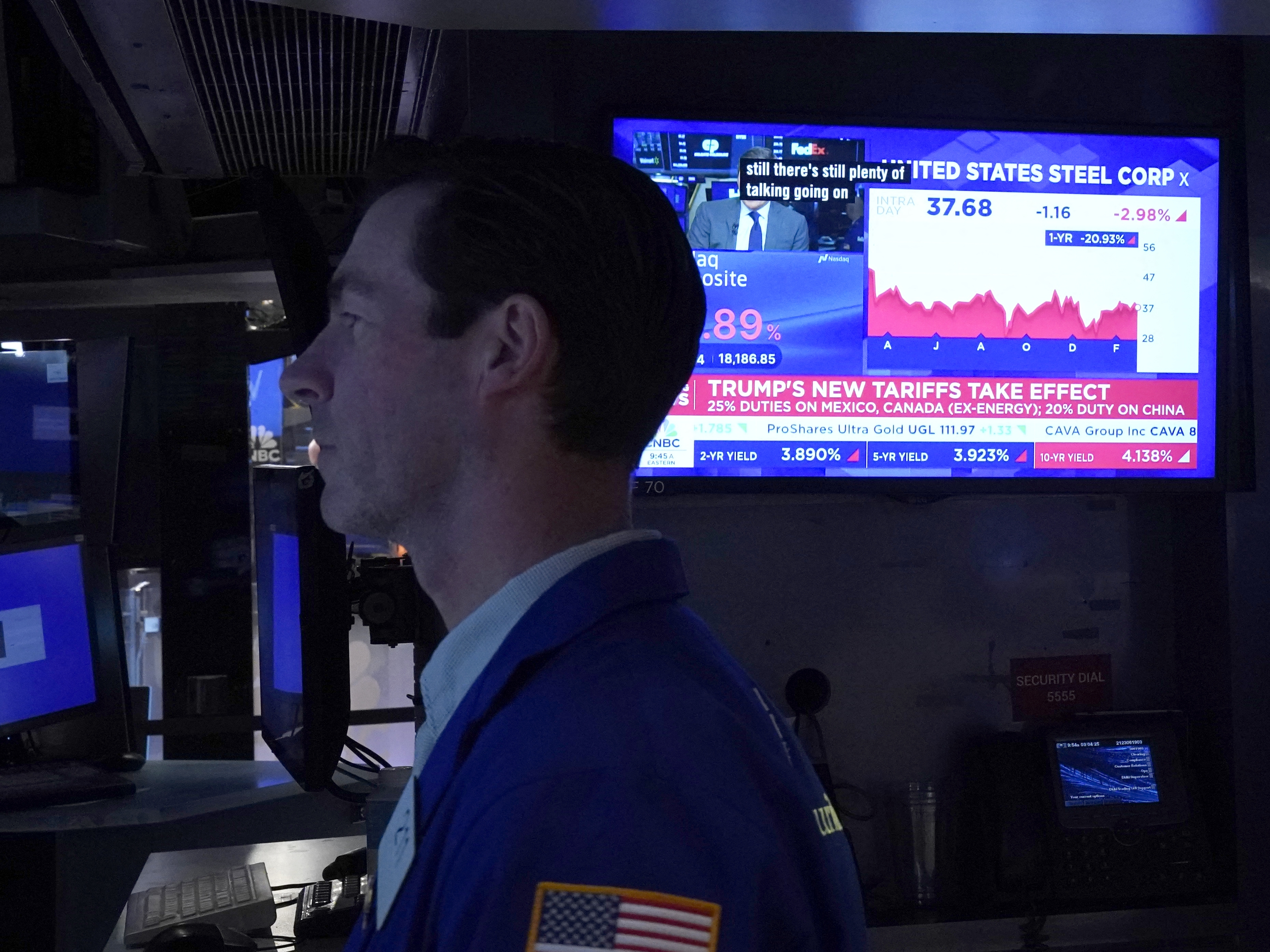 caption: Traders work on the floor of the New York Stock Exchange in the Financial District in New York City on Tuesday.