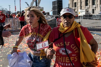 caption: People flee after shots were fired near the Kansas City Chiefs' Super Bowl victory parade on Feb.14 in Kansas City, Mo.