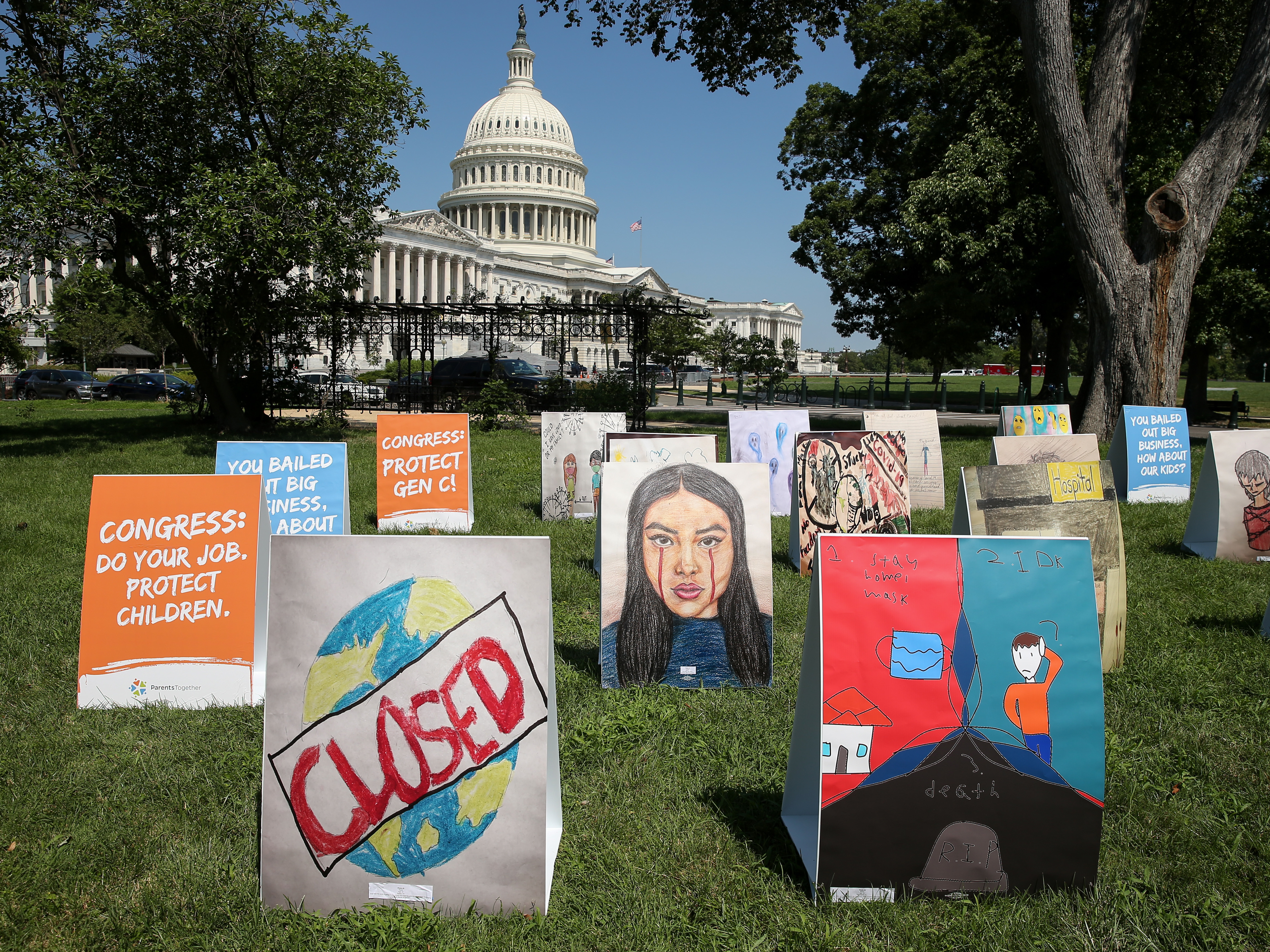 caption: An installation of children's art is set up outside the Capitol on Wednesday. Kids can develop "severe" symptoms from the coronavirus, the Centers for Disease Control and Prevention said in a report released Friday.