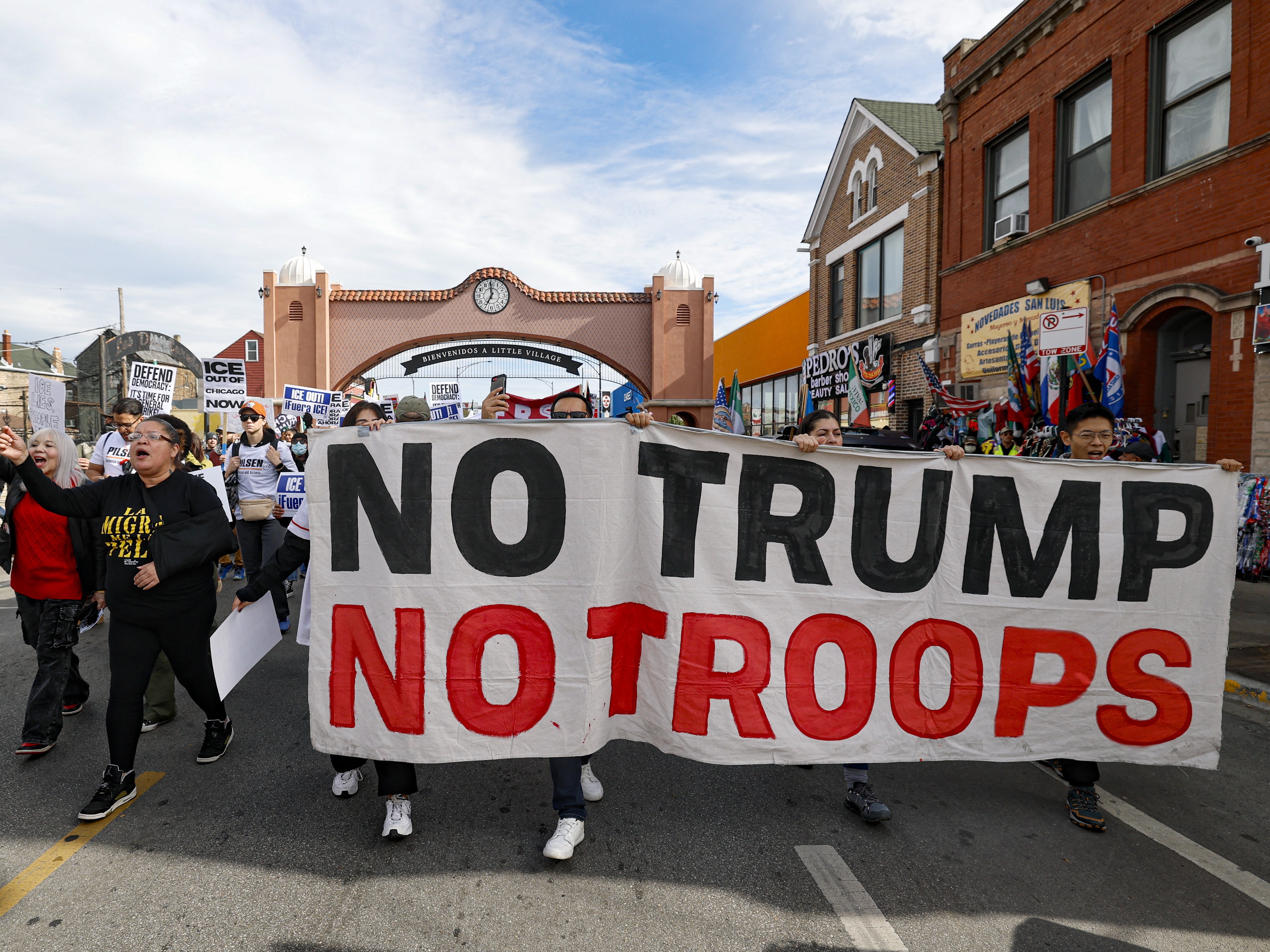 caption: Protesters march against the use of ICE and other federal law enforcement in Chicago on Oct. 25.