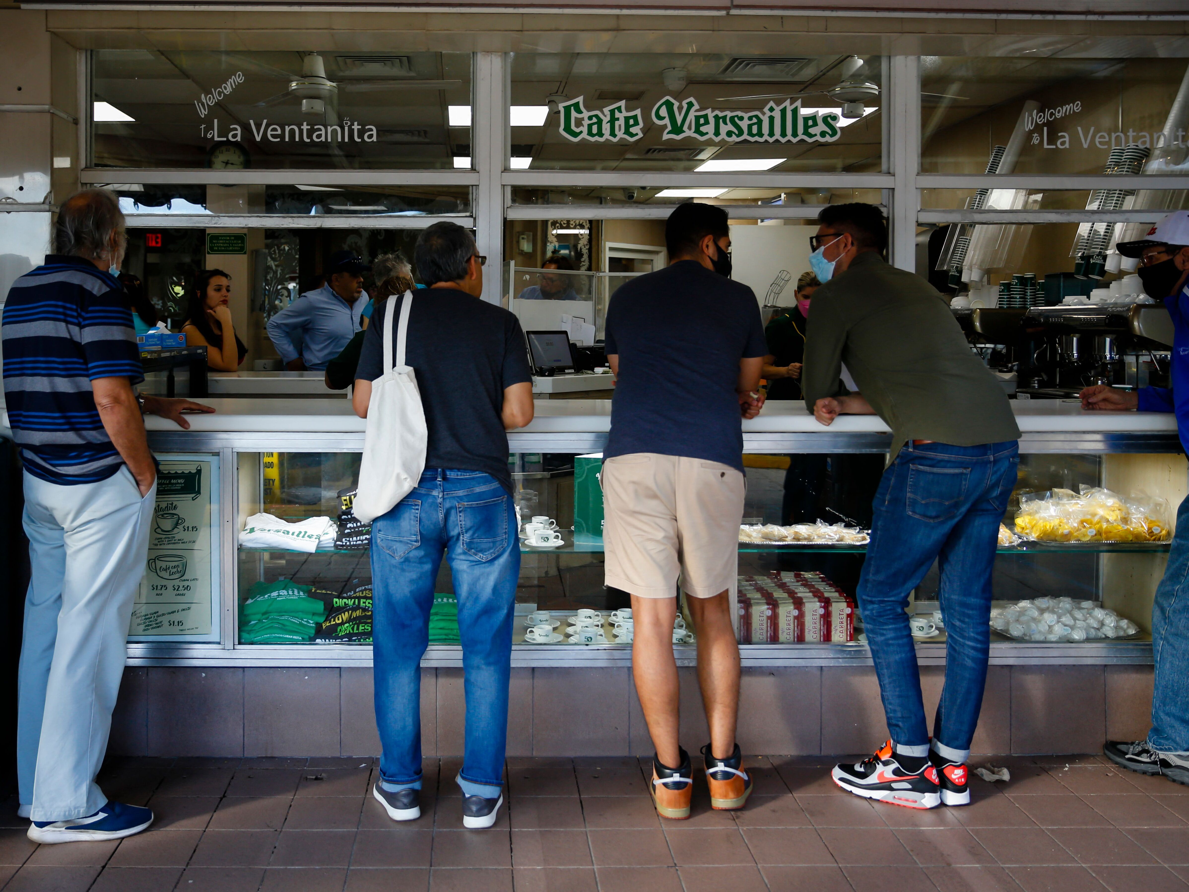 caption: "Ventanitas" are popular spots where Cuban-Americans and others in Miami gather for coffee and conversation.<br>