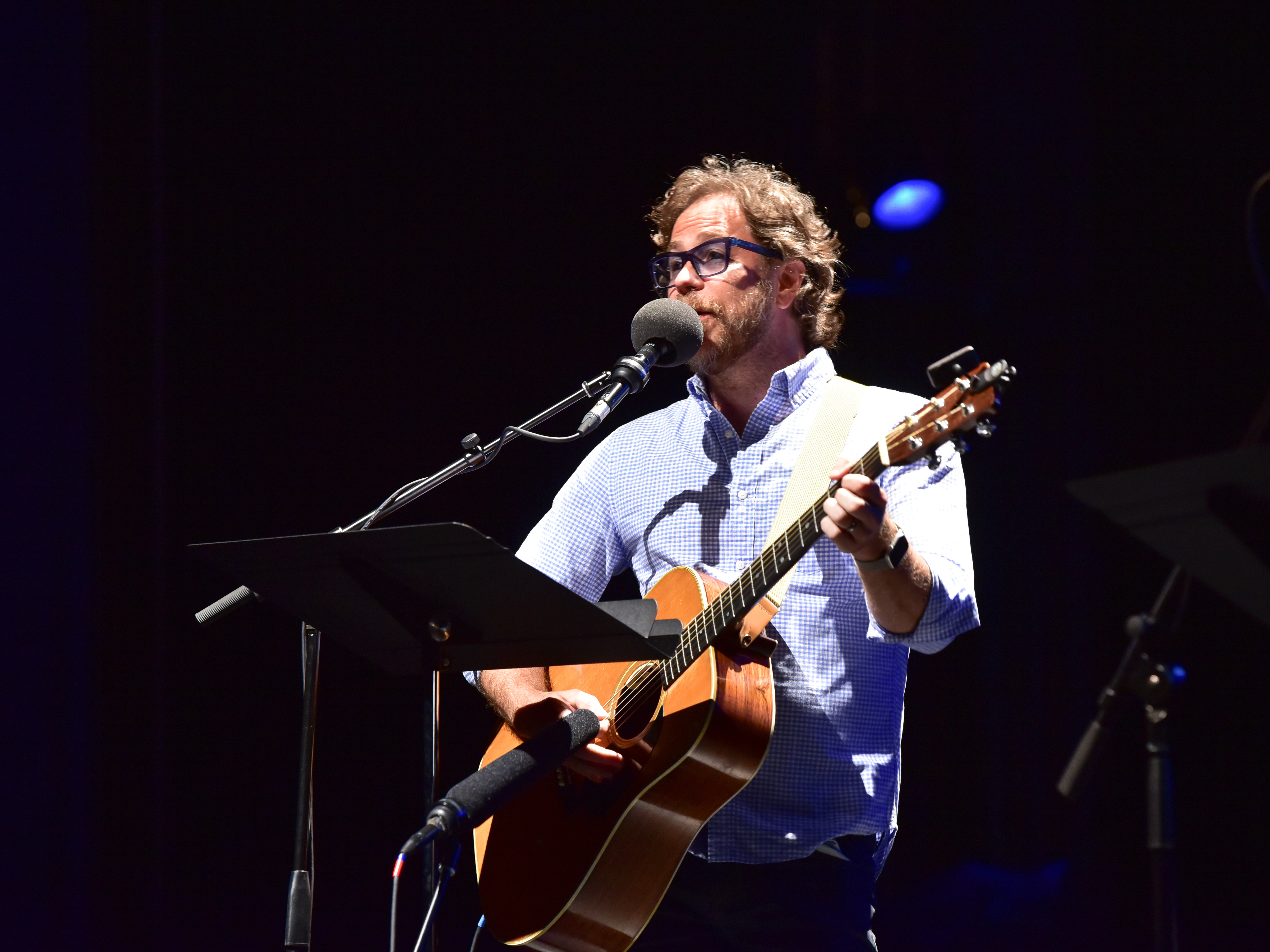 caption: <em>Ask Me Another</em> house musician Jonathan Coulton performs at the Majestic Theatre in Dallas, Texas.