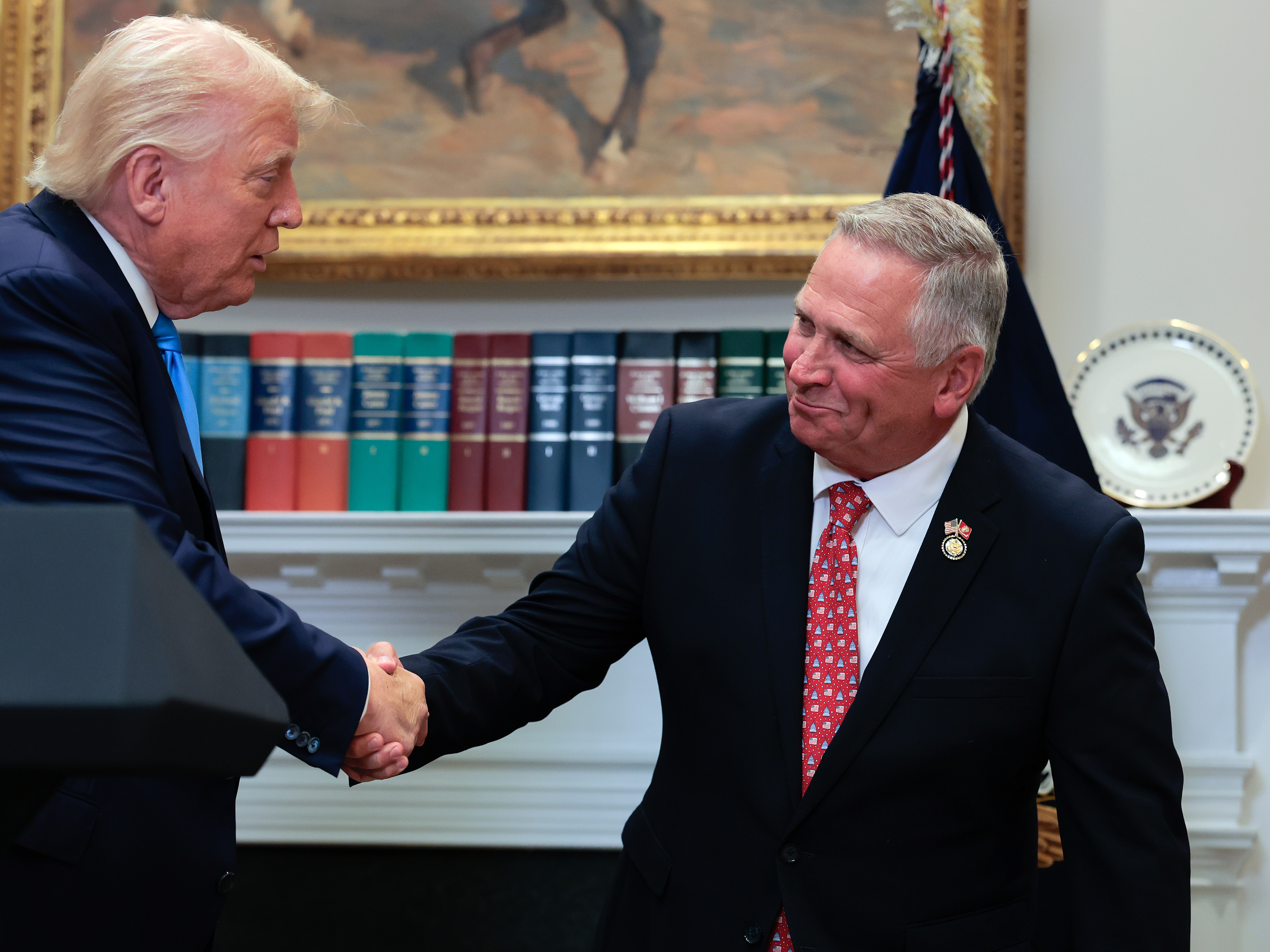 caption: The U.S. Supreme Court has ruled that Illinois Republican U.S. Rep. Mike Bost — seen here with President Trump — has the legal standing to challenge a state law about mail ballots.