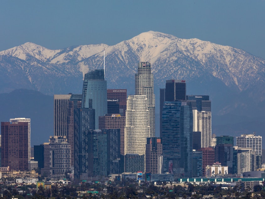 caption: The San Gabriel Mountains are seen under a clear sky beyond downtown Los Angeles. Air quality in the U.S. and elsewhere has been improved by reduced traffic from coronavirus restrictions and weeks of rainstorms.