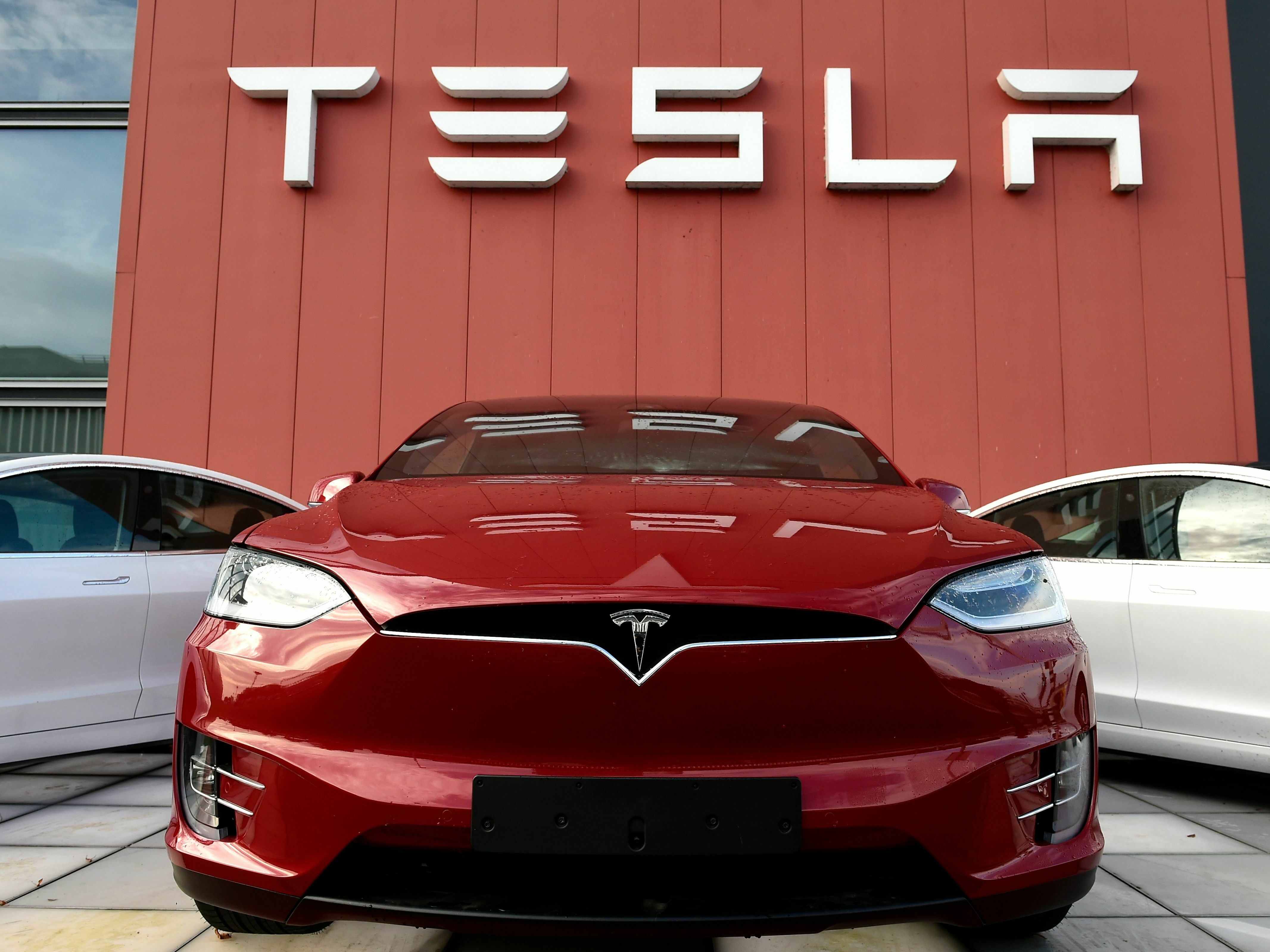 caption: A Tesla car is displayed at a showroom and service center for the auto maker in Amsterdam on Oct. 23, 2019. Tesla recently cut prices across the board, a move with big potential ramifications for the automaker as well as for the industry.