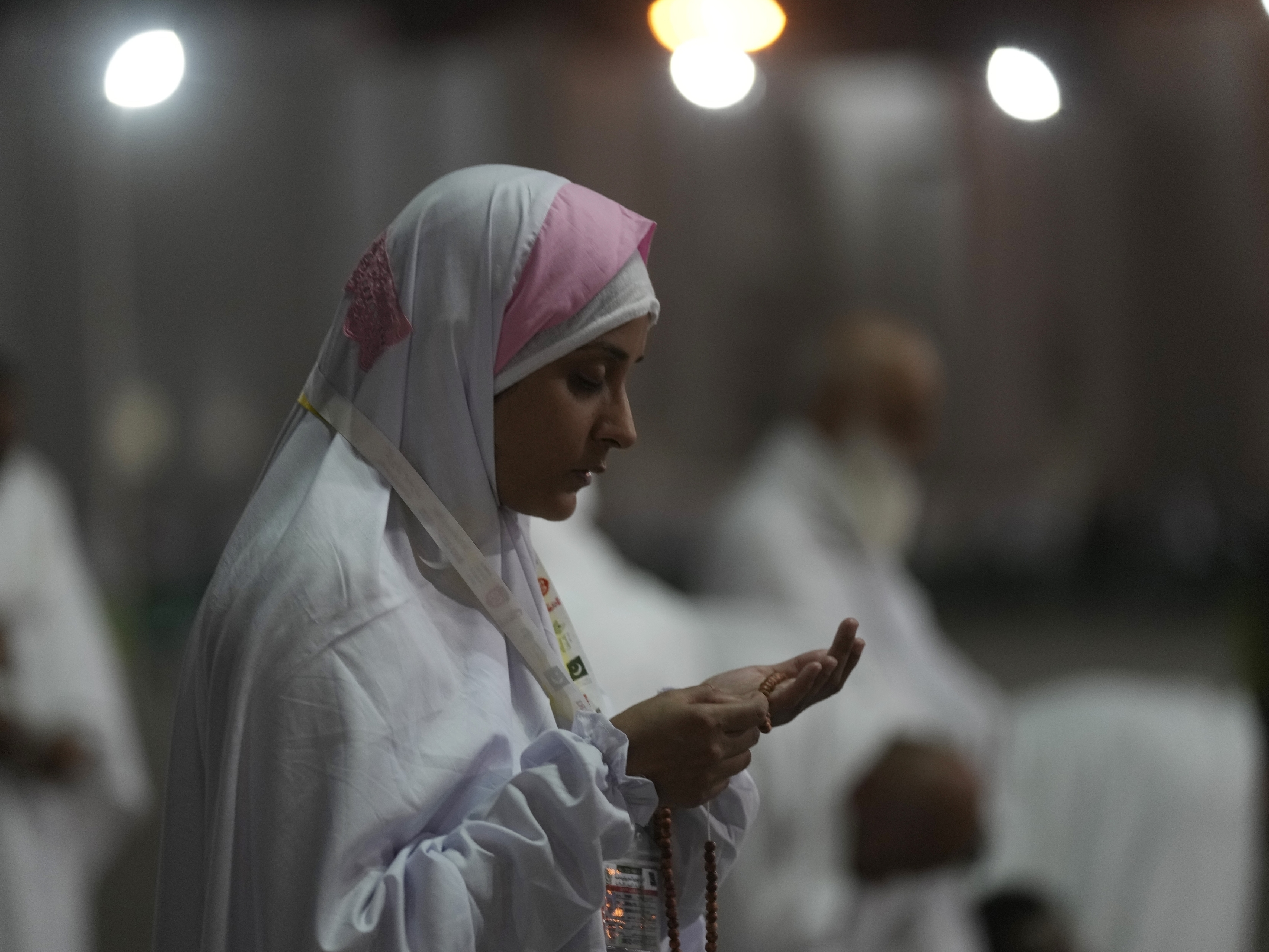 caption: A Muslim pilgrim prays on the Plain of Arafat, during the annual hajj pilgrimage, near the holy city of Mecca, Saudi Arabia, Friday, July 8, 2022.