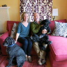 caption: Kristin Rowe-Finkbeiner, Bill Finkbeiner and the dogs they argue about. 