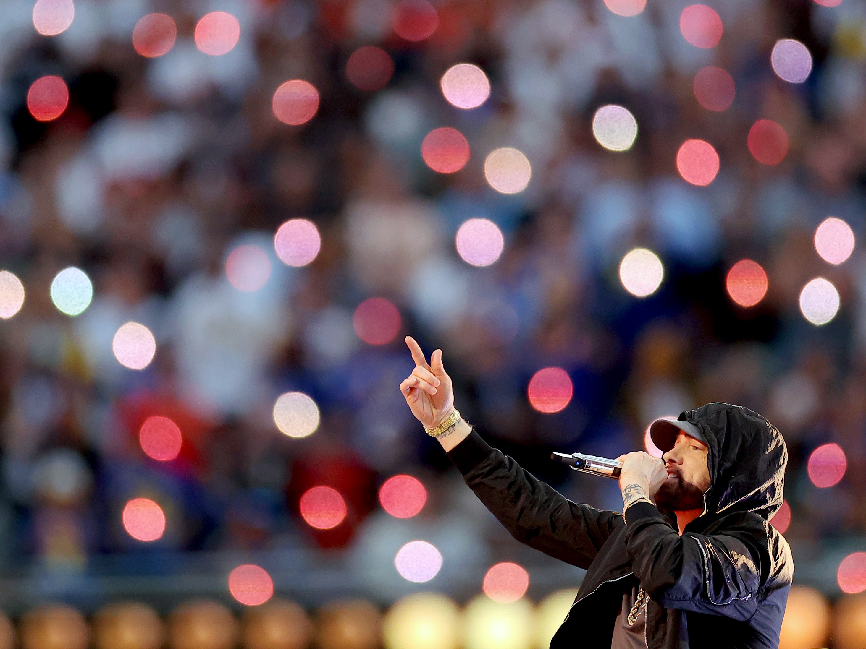 caption: Eminem, performing here during the Super Bowl LVI Halftime Show at SoFi Stadium in 2022, returns to the top 10 of the <em>Billboard</em> Hot 100 chart this week with "Houdini."