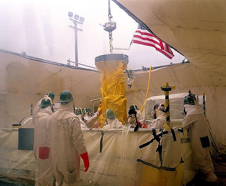 caption: Workers conduct routine monitoring of the tanks at Hanford.