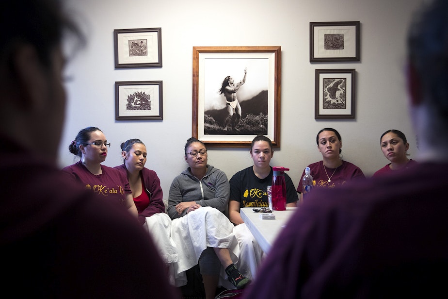 caption: Dancers listen to Kumu Hula Kamaile Hamada, not pictured, during practice on Friday, March 16, 2018, at the halau in Federal Way.