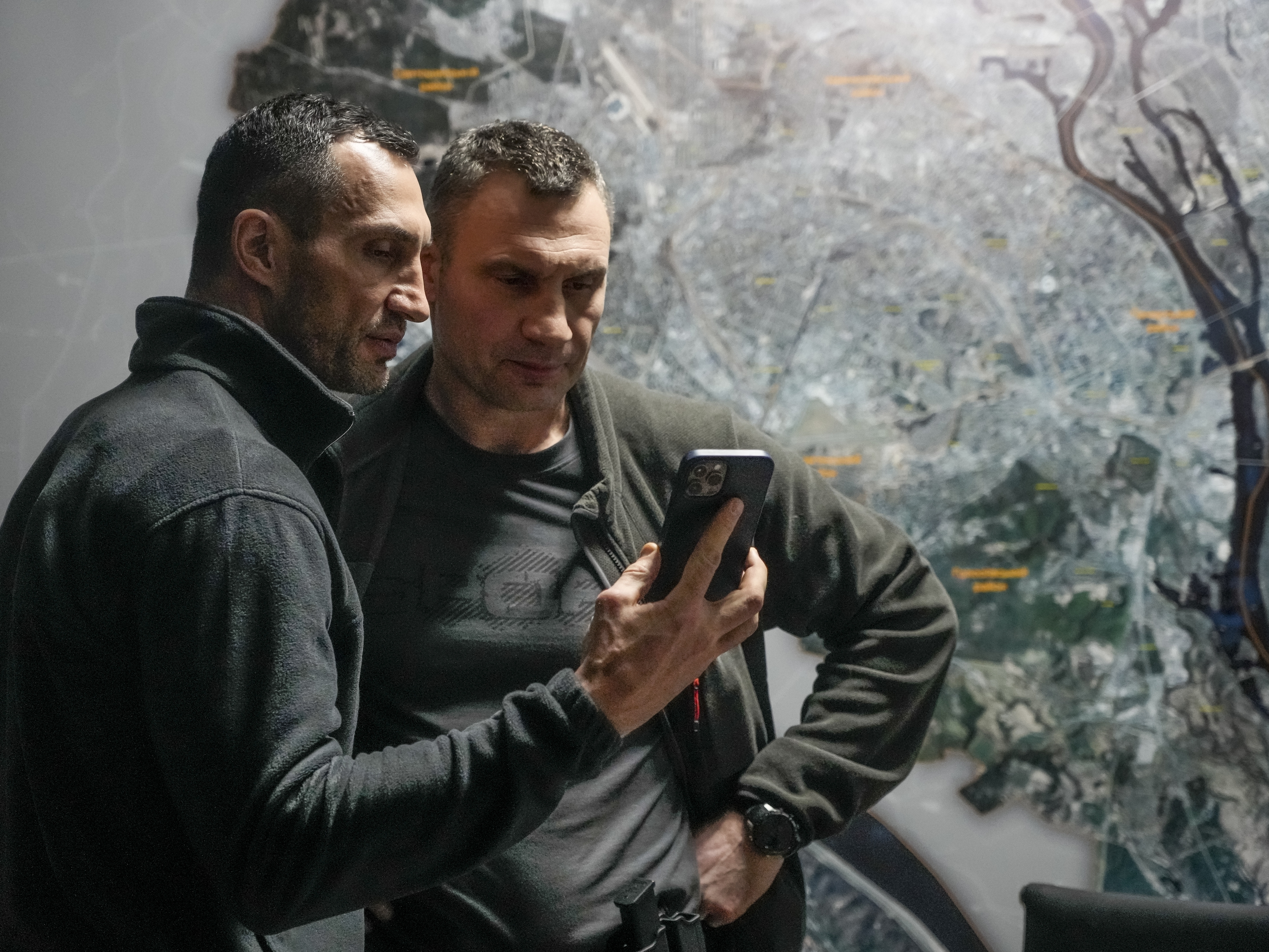 caption: Kyiv Mayor Vitali Klitschko (right) and his brother Wladimir Klitschko check a phone at city hall on Feb. 27. When Russia invaded Ukraine, many expected Moscow to knock out the Ukrainian communications network. But Ukrainian systems, for both civilians and the military, continue to function. Ukraine, meanwhile, has regularly intercepted Russian military communications.