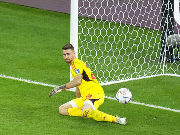caption: Morocco's Achraf Hakimi scores the decisive penalty Tuesday past Spain's goalkeeper Unai Simon at the end a round of 16 World Cup soccer match at the Education City Stadium in Al Rayyan, Qatar.