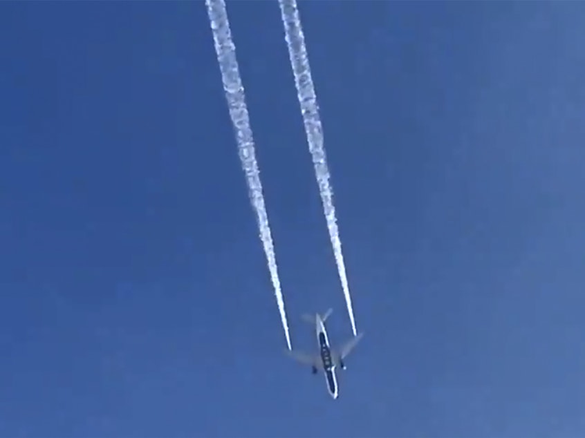 caption: In this image from video, Delta Air Lines Flight 89 to Shanghai, China, dumps fuel over Los Angeles before returning to Los Angeles International Airport for a safe emergency landing on Tuesday. Fire officials say fuel apparently dumped by the plane fell onto an elementary school playground.