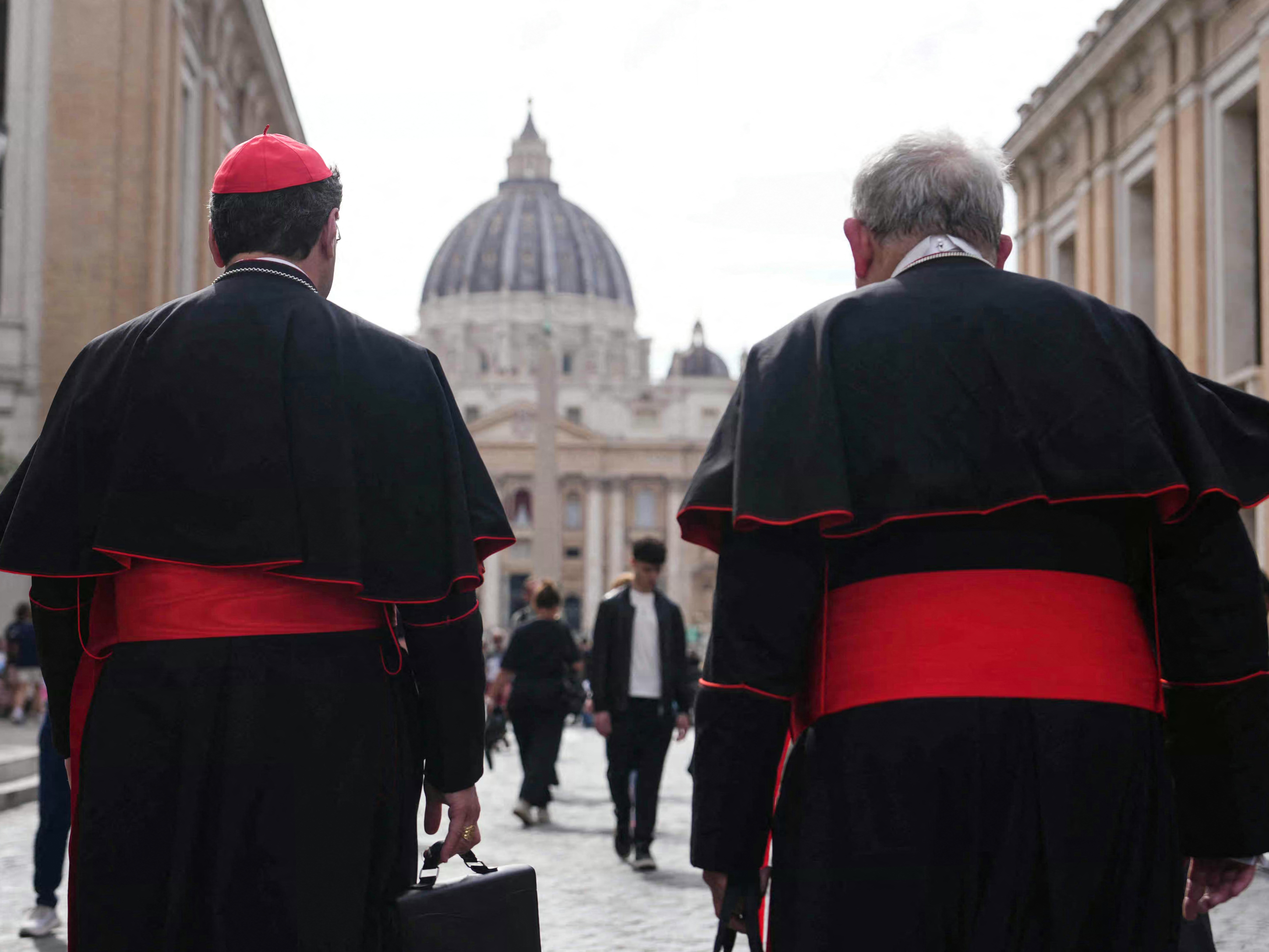 caption: Canadian Cardinal Thomas Christopher Collins (right) and Cardinal Francis Leo walk on Via della Conciliazione street near the Vatican, with St. Peter's Basilica in the background, in Rome on Monday.