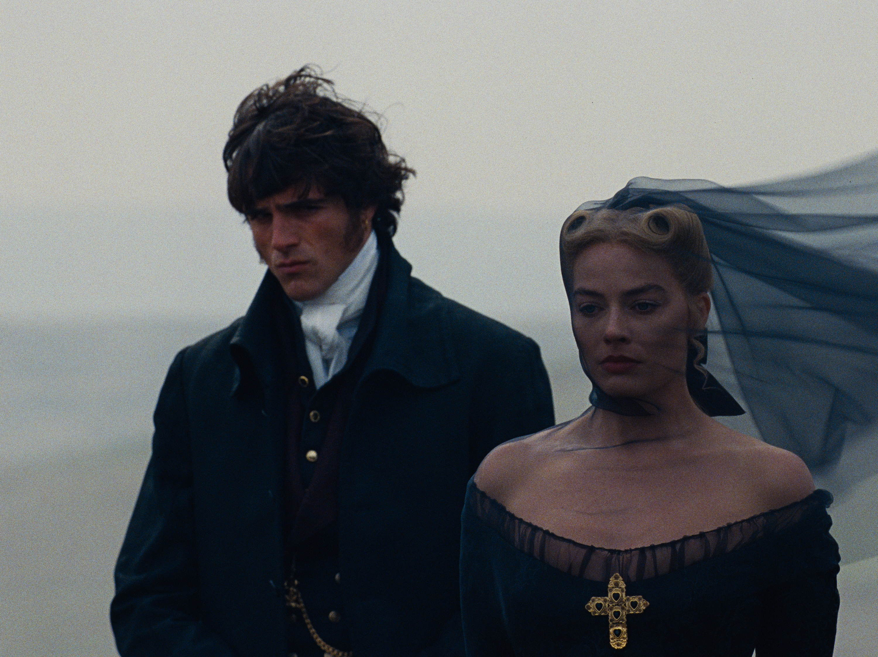 caption: Jacob Elordi and Margot Robbie play ill-fated lovers Heathcliff and Catherine in "<em>Wuthering Heights."</em>
