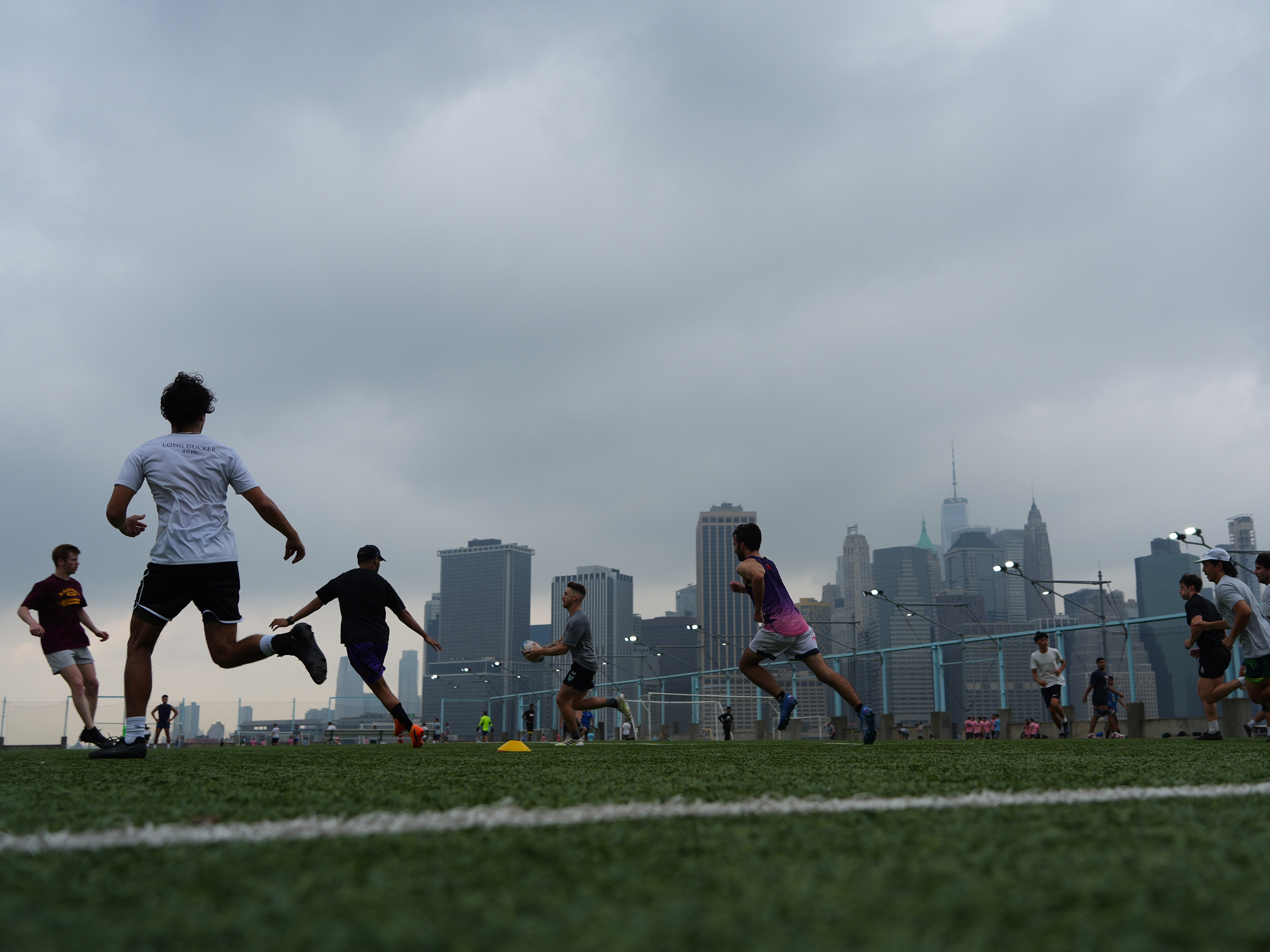 caption: People play rugby in the hazy weather on July 27, 2025 in New York City. There are currently smoke advisories across the Midwest and Northeast as a result of wildfires in Canada.<br>