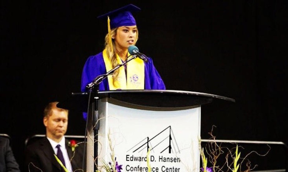 caption: Ivy Jacobsen speaking about her abuse at her high school graduation.